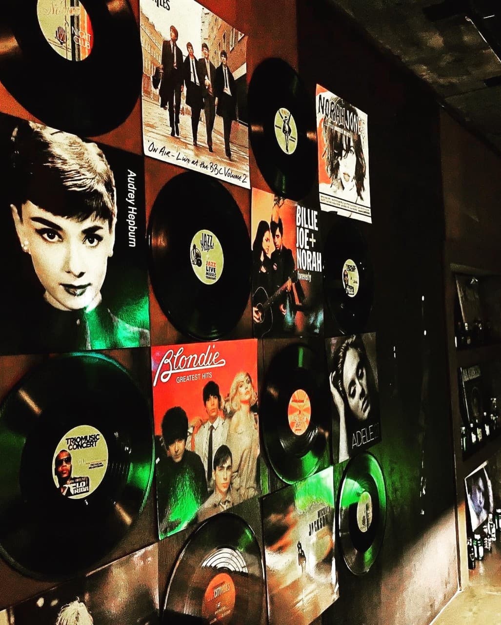 부산광역시 중구 맥주 호프 풍악 - LP판과 포스터로 꾸며진 벽면과 조명이 비치는 혼술 다찌석 공간