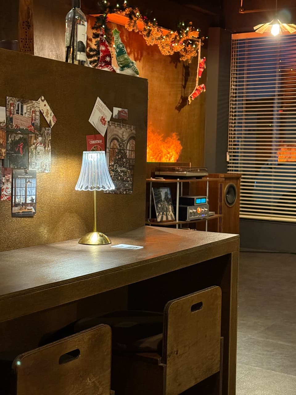 경상남도 진주시 고효 진주 와인바. 테이블 조명이 켜진 1인 다찌석과 크리스마스 가랜드. LP 플레이어와 오디오가 배치된 공간에서 즐기는 혼술 상황.