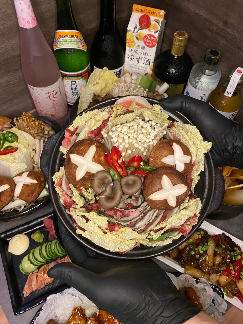 경상남도 진주시 청월 진주평거점 진주 이자카야 다찌석 조명 아래 차려진 1인 밀푀유나베. 소고기와 표고버섯 질감이 강조된 전골 배치를 통한 혼술 분위기.