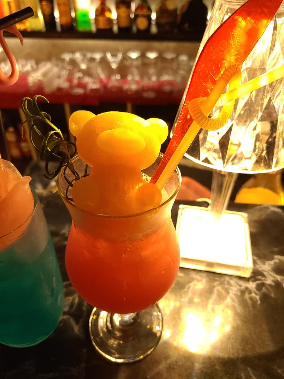 경상북도 경산시 비사이드 경북 바(Bar) 다찌석 위 곰돌이 모양 얼음이 올라간 칵테일과 조명. 대리석 테이블에서 혼자 즐기는 1인 혼술 상황.